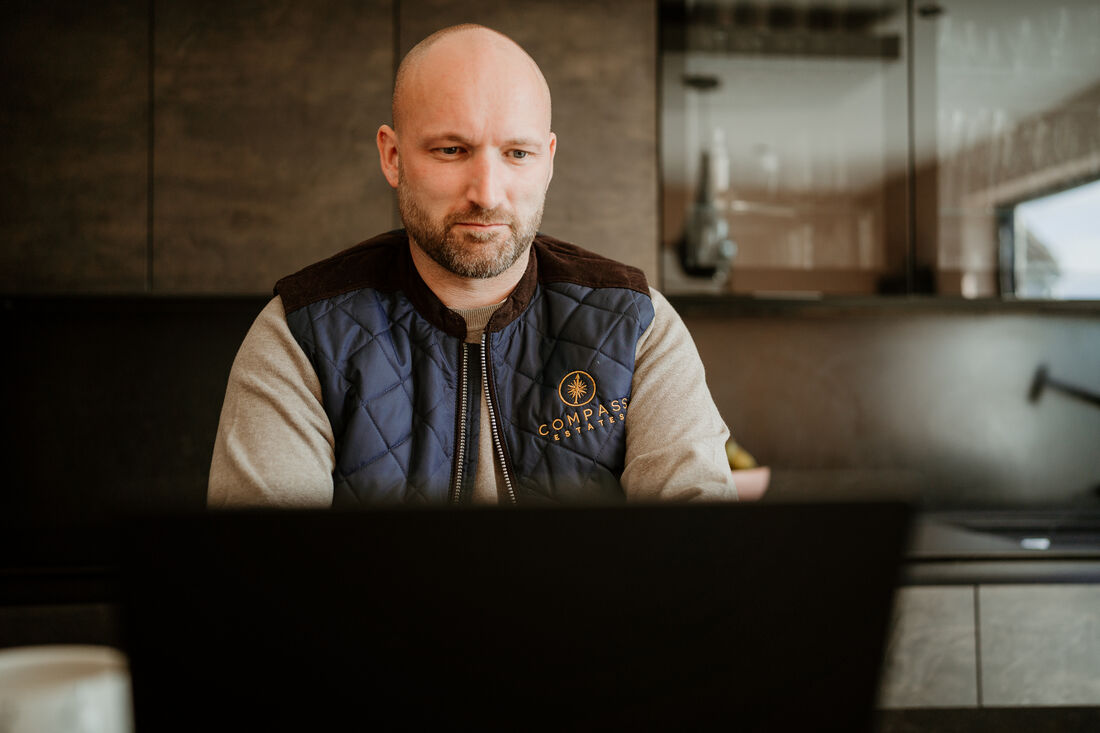 Duncan Ure working at his desk, Compass Estates